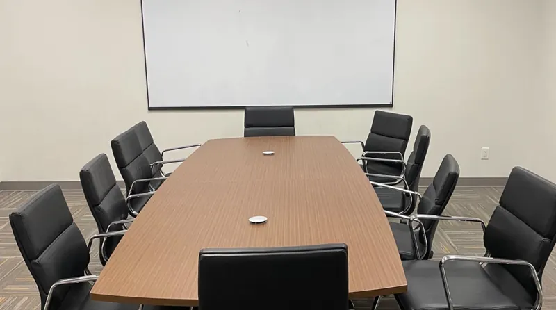 An empty meeting room with a long table