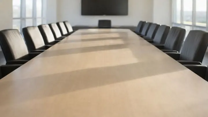 An empty meeting room with a long table