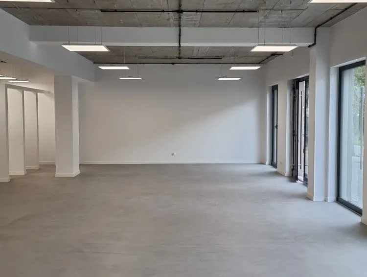 An empty office with desks and natural light