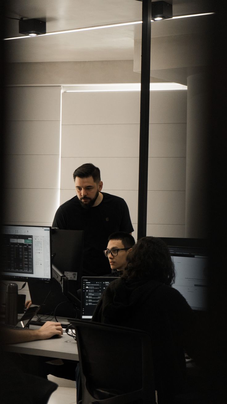 Engineers following a process on screen at their desks