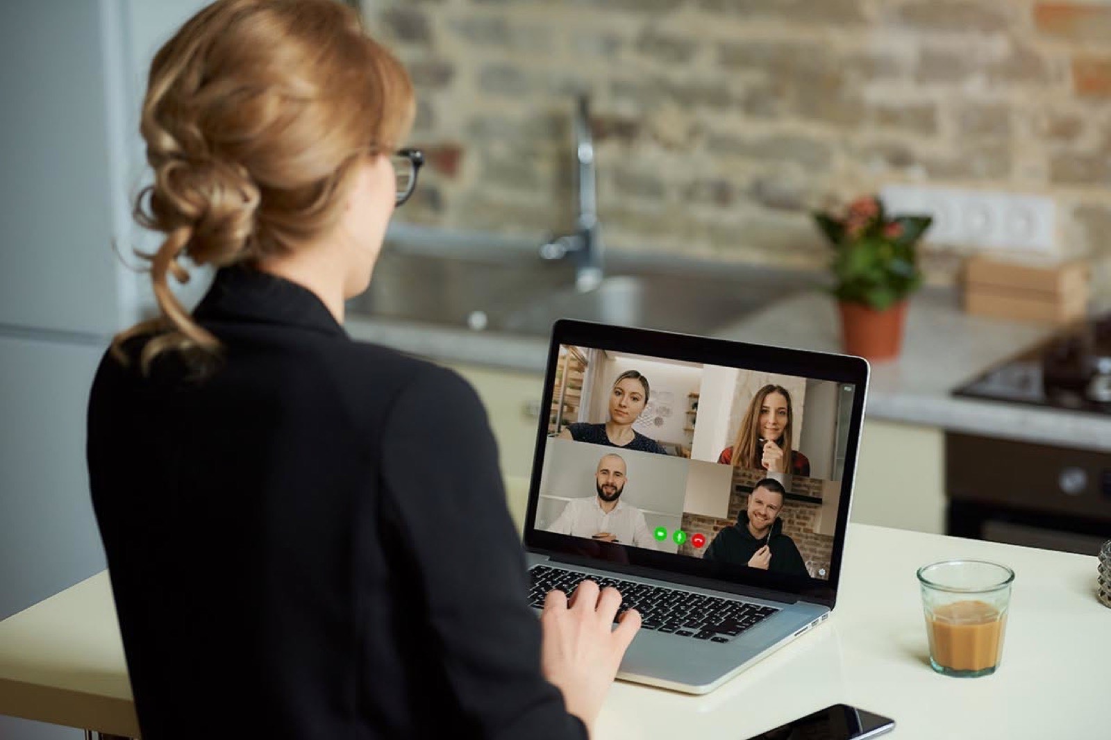 A person on a remote video call from a laptop