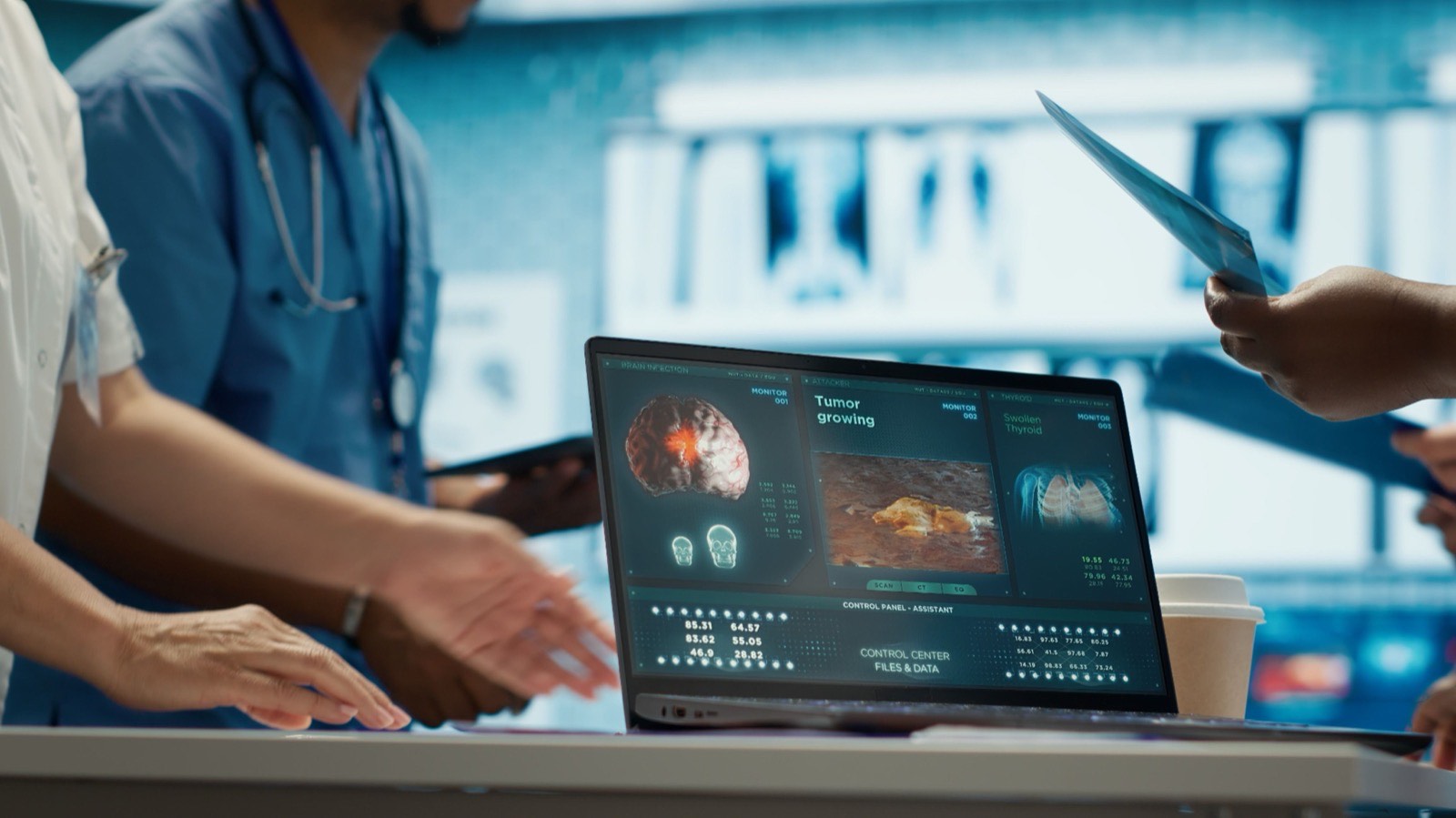 Clinicians reviewing patient information on a laptop and a tablet